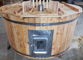 Wooden hot tub with the integrated furnace.