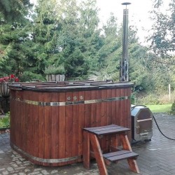 Plastic hot tub with spruce trim and the external furnace.